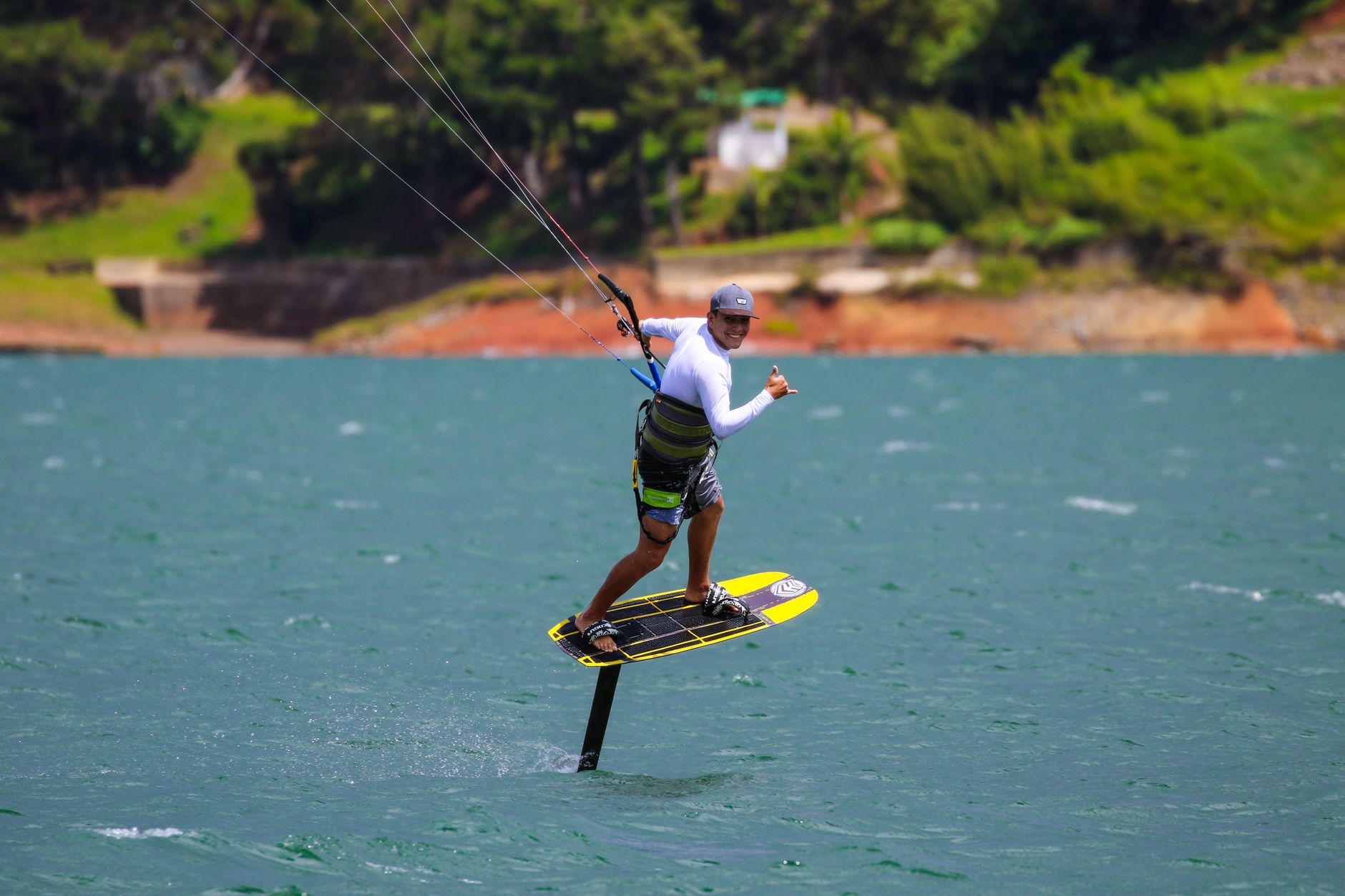 Foilboarder frente a una costa verde