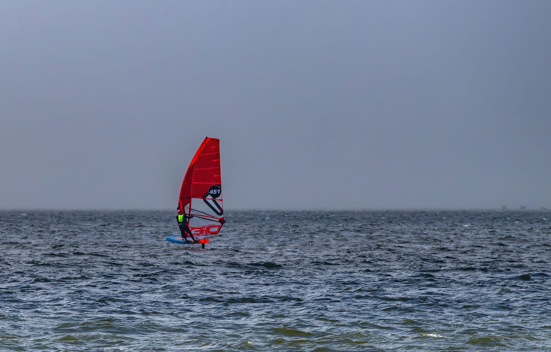 Windsurfista com vela na água