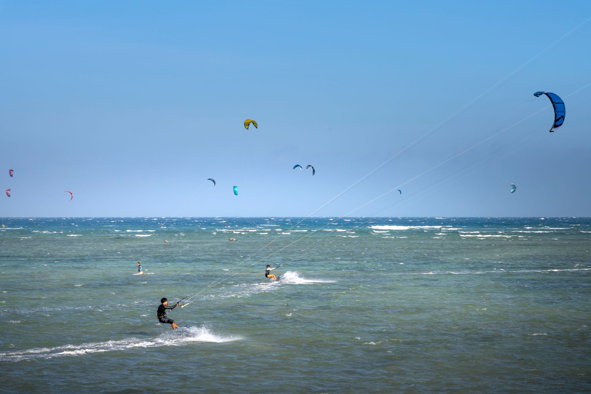Kitesurfista navega com o kite levantado
